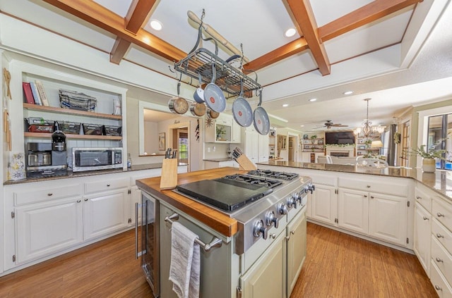 kitchen featuring white cabinetry, a ceiling fan, coffered ceiling, and light wood-type flooring