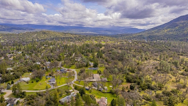 birds eye view of property with a wooded view and a mountain view