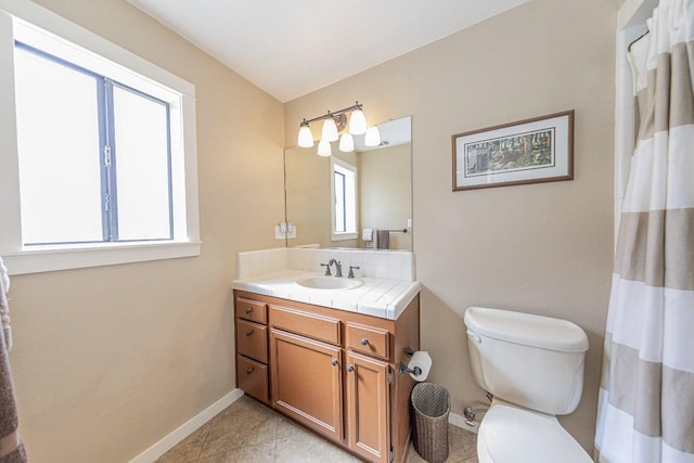 full bathroom featuring baseboards, toilet, vanity, and tile patterned floors