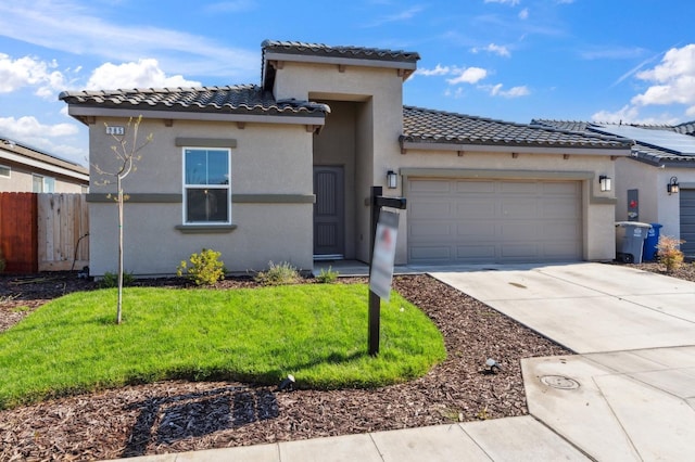 mediterranean / spanish-style home featuring a tiled roof, stucco siding, fence, an attached garage, and driveway