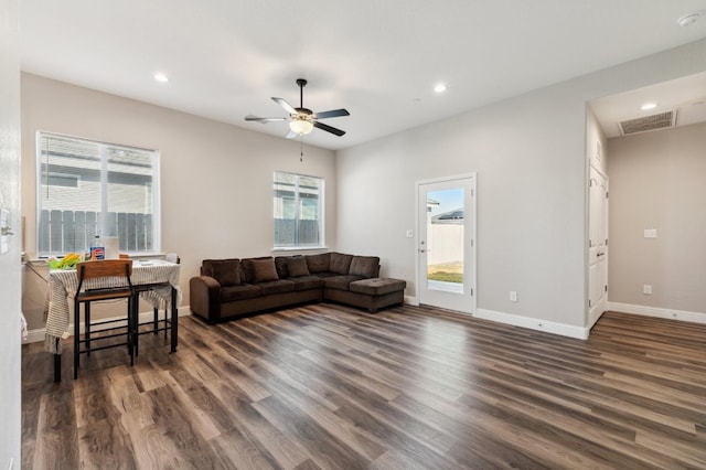 living room with dark wood-style floors and a healthy amount of sunlight