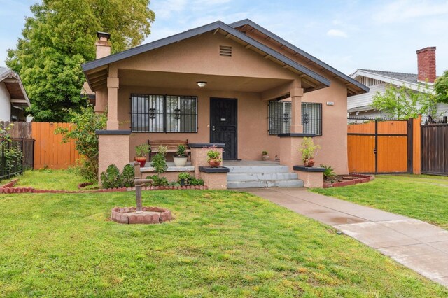 3154 E Montecito Ave, Fresno, CA 93702 - bungalow-style house with stucco siding, a chimney, and covered porch
