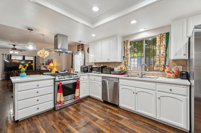 3154 E Montecito Ave, Fresno, CA 93702 - kitchen with stainless steel appliances, island range hood, a peninsula, a tray ceiling, and ornamental molding
