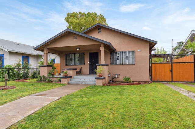 3154 E Montecito Ave, Fresno, CA 93702 - bungalow featuring stucco siding, a porch, and a gate