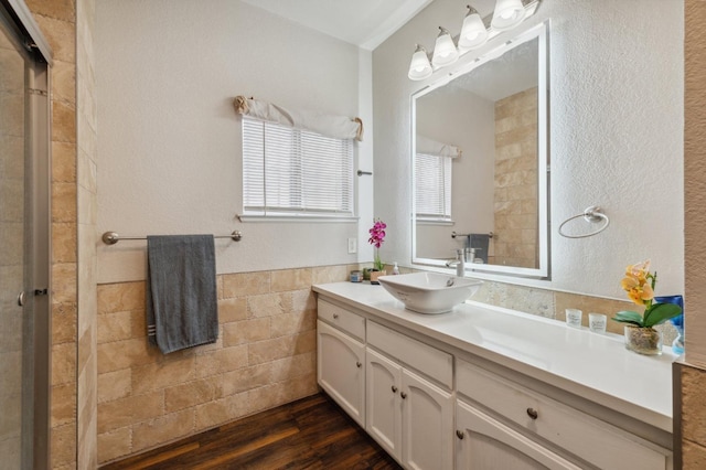 3154 E Montecito Ave, Fresno, CA 93702 - bathroom with vanity, wood finished floors, tiled shower, and wainscoting