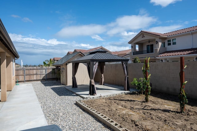 view of yard with a fenced backyard, a gazebo, and a patio area