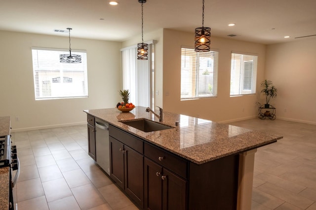 kitchen with stainless steel appliances, recessed lighting, dark brown cabinetry, a sink, and pendant lighting