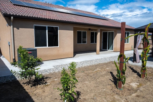 back of property featuring ceiling fan, central AC, a tile roof, stucco siding, and a patio area