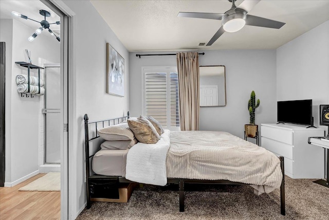 bedroom with wood finished floors, visible vents, baseboards, and ceiling fan