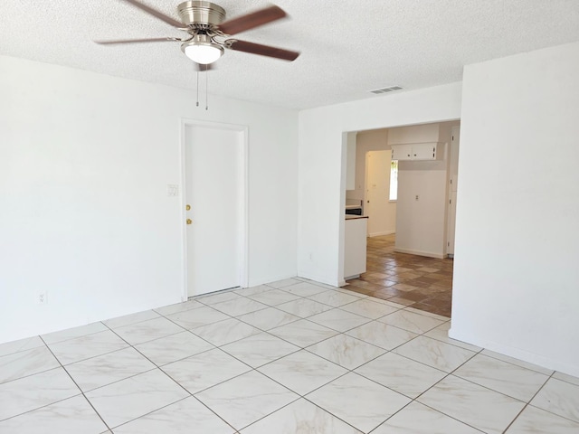 4571 N Kavanagh Ave, Fresno, CA 93705 - empty room with ceiling fan and a textured ceiling