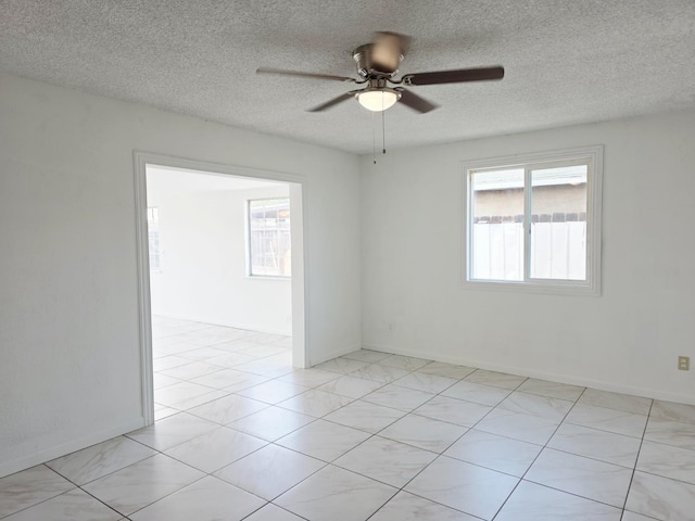 4571 N Kavanagh Ave, Fresno, CA 93705 - unfurnished room with ceiling fan, a textured ceiling, baseboards, and light tile patterned floors