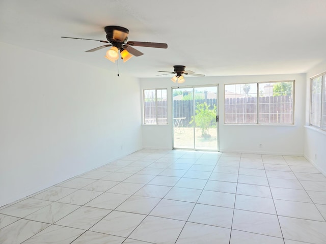 4571 N Kavanagh Ave, Fresno, CA 93705 - unfurnished room with ceiling fan, light tile patterned flooring, and baseboards