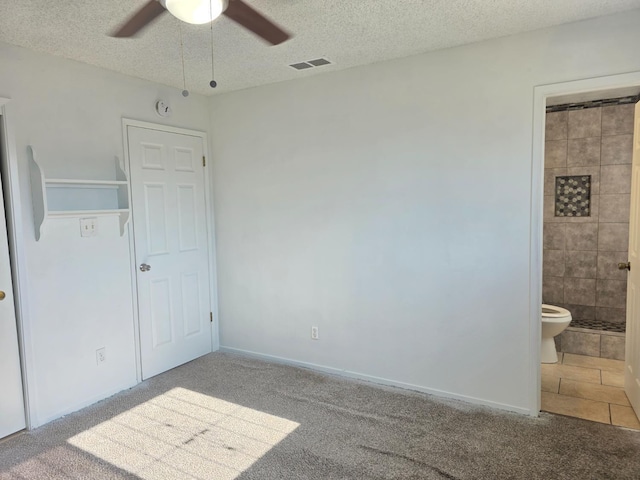4571 N Kavanagh Ave, Fresno, CA 93705 - unfurnished bedroom with carpet floors, a textured ceiling, ensuite bathroom, and ceiling fan