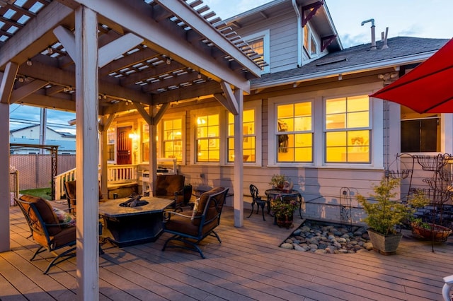 wooden deck with an outdoor fire pit and fence