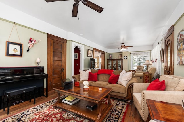 living room featuring a ceiling fan and wood finished floors