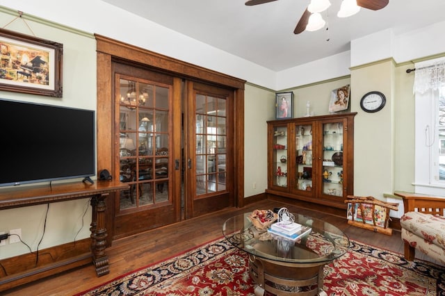 living room with ceiling fan and wood finished floors