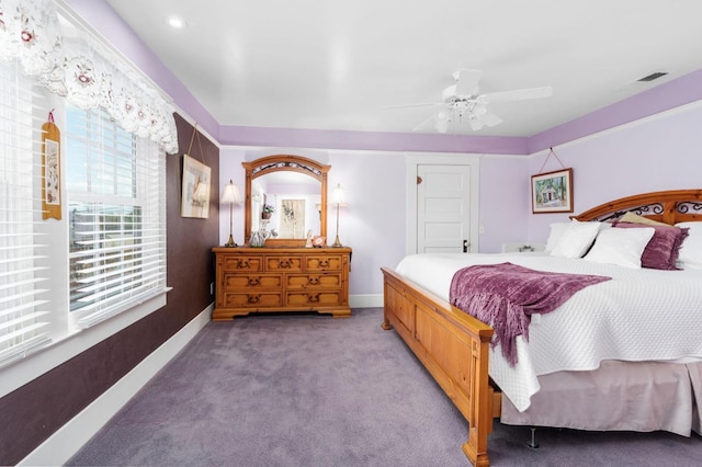 carpeted bedroom with baseboards, ceiling fan, and visible vents