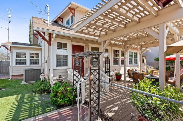 view of patio featuring a pergola, central AC unit, and fence