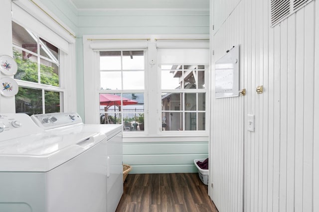 laundry room featuring a wealth of natural light, washing machine and dryer, laundry area, and dark wood-style floors