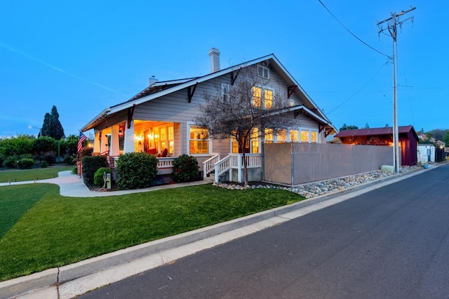 view of front of property with a front yard and fence