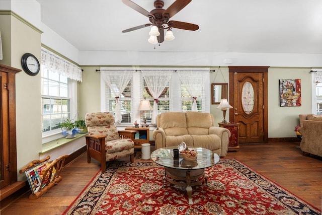 living room featuring baseboards, ceiling fan, and wood-type flooring