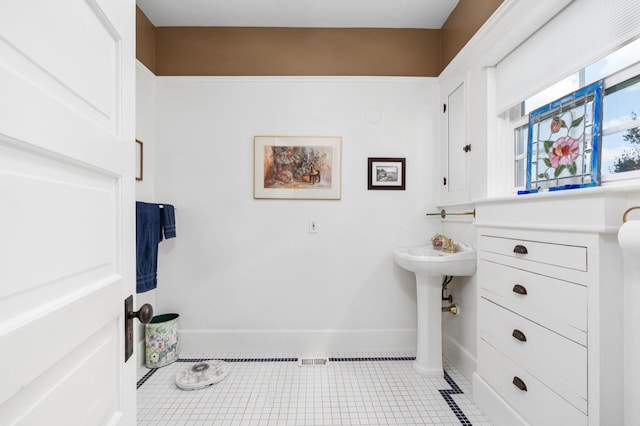 bathroom featuring baseboards and tile patterned floors