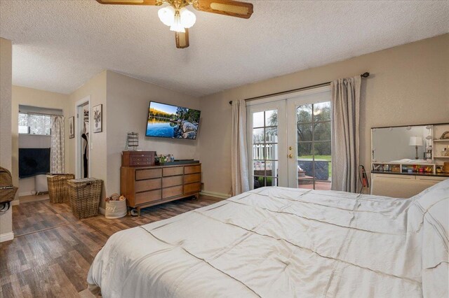 bedroom with french doors, a textured ceiling, access to exterior, a ceiling fan, and wood finished floors