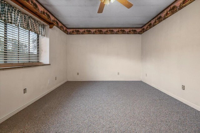carpeted spare room with baseboards and ceiling fan