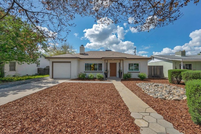 ranch-style house with driveway, an attached garage, fence, and a chimney