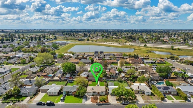 bird's eye view with a residential view and a water view