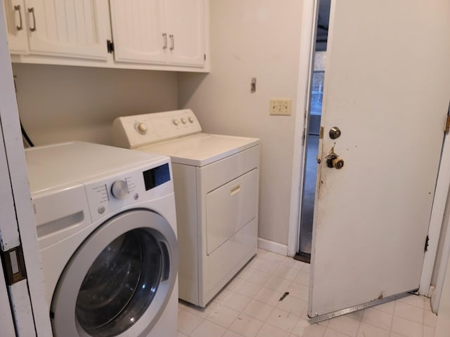 laundry area with baseboards, cabinet space, and independent washer and dryer
