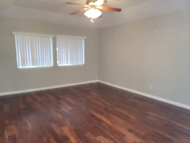 unfurnished room featuring baseboards, a ceiling fan, and wood finished floors