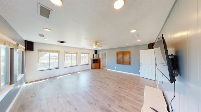 2299 N Garfield Ave, Fresno, CA 93723 - unfurnished living room with a ceiling fan, light wood-type flooring, a textured ceiling, recessed lighting, and baseboards