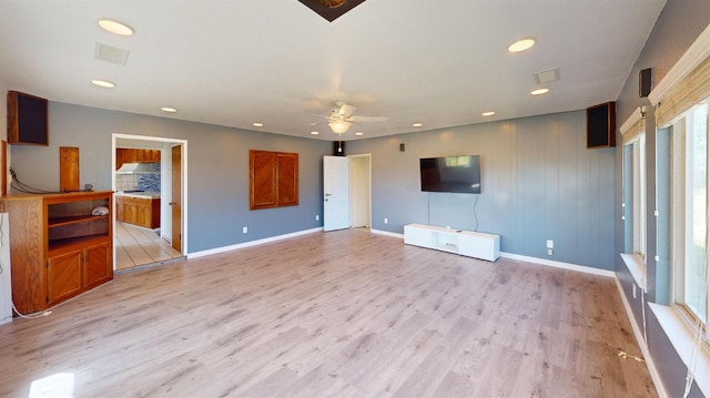 2299 N Garfield Ave, Fresno, CA 93723 - unfurnished living room with light wood-style flooring, a ceiling fan, recessed lighting, and baseboards