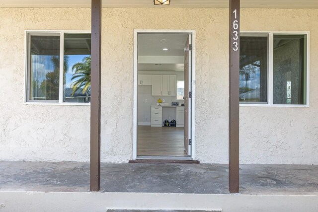 1633 W Saginaw Way, Fresno, CA 93705 - doorway to property featuring stucco siding
