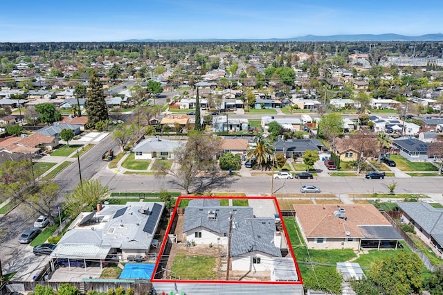 1633 W Saginaw Way, Fresno, CA 93705 - aerial view of residential area featuring property parcel outlined and a mountainous background
