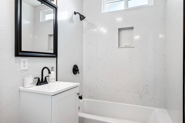 1633 W Saginaw Way, Fresno, CA 93705 - full bathroom featuring vanity, washtub / shower combination, and healthy amount of natural light