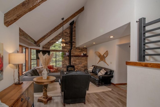 38660 Woodland Rd, Shaver Lake, CA 93664 - living area with a wood stove, high vaulted ceiling, light wood-style flooring, beamed ceiling, and stairway