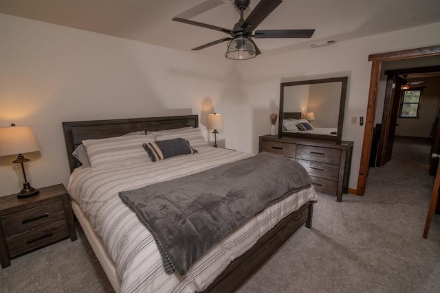 carpeted bedroom with visible vents and ceiling fan
