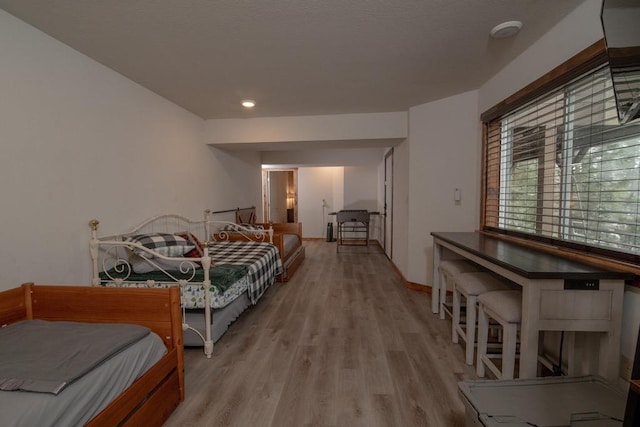 bedroom featuring recessed lighting, light wood-style floors, and baseboards
