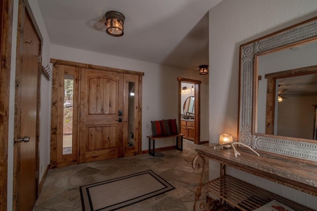 38660 Woodland Rd, Shaver Lake, CA 93664 - entrance foyer featuring light stone finish flooring and baseboards