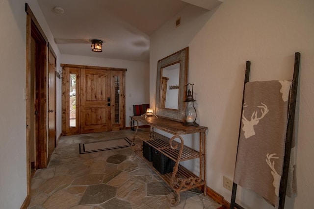 interior space with visible vents, baseboards, and stone flooring