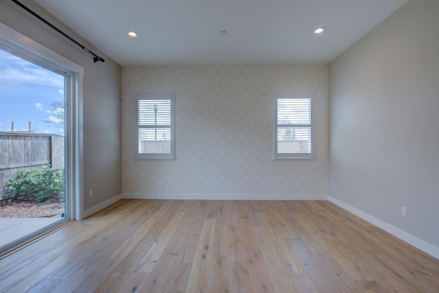 2791 E Tuolumne Rd, Turlock, CA 95382 - spare room with wallpapered walls, baseboards, light wood finished floors, recessed lighting, and plenty of natural light