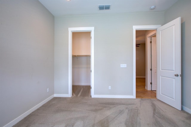 2791 E Tuolumne Rd, Turlock, CA 95382 - unfurnished bedroom featuring carpet, baseboards, a walk in closet, and a closet