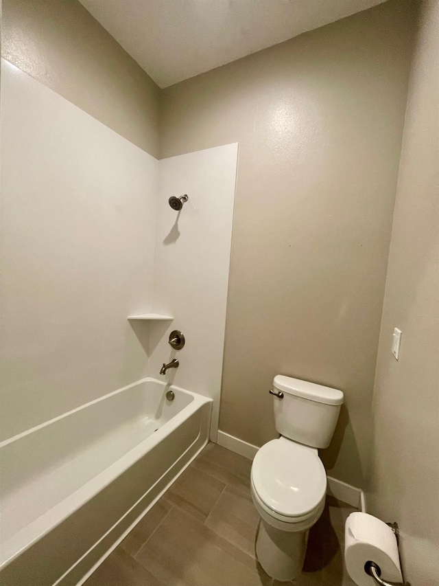 2791 E Tuolumne Rd, Turlock, CA 95382 - bathroom with toilet, bathtub / shower combination, and baseboards