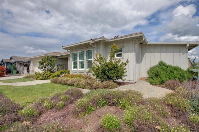 2791 E Tuolumne Rd, Turlock, CA 95382 - view of property exterior with an attached garage and a lawn