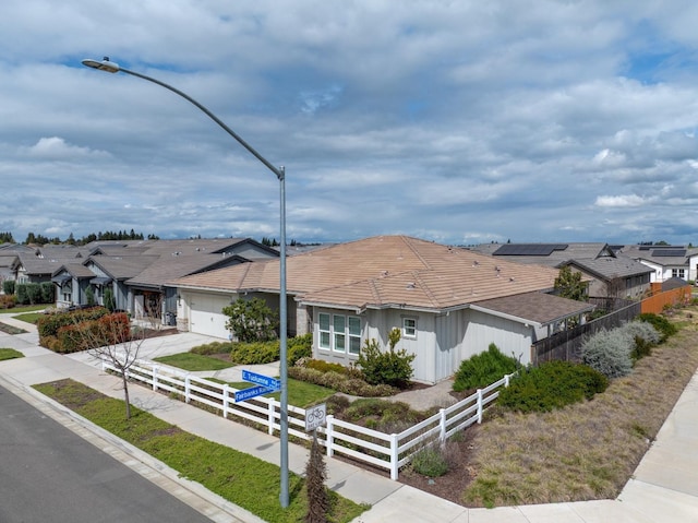 2791 E Tuolumne Rd, Turlock, CA 95382 - ranch-style home featuring an attached garage, a residential view, driveway, and a tile roof