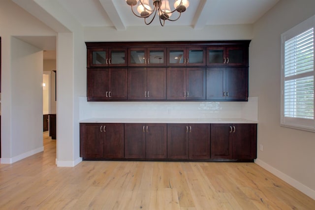 2791 E Tuolumne Rd, Turlock, CA 95382 - unfurnished dining area featuring beamed ceiling, a chandelier, light wood-style flooring, plenty of natural light, and baseboards