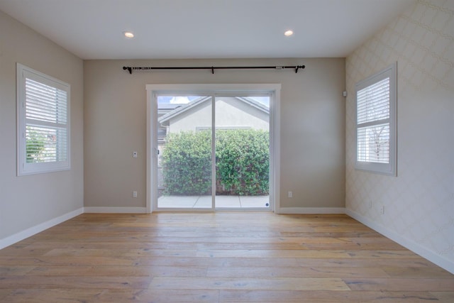 2791 E Tuolumne Rd, Turlock, CA 95382 - unfurnished room with wallpapered walls, plenty of natural light, light wood-style flooring, baseboards, and recessed lighting