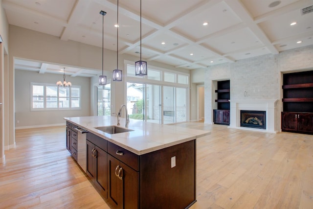 2791 E Tuolumne Rd, Turlock, CA 95382 - kitchen featuring coffered ceiling, a sink, baseboards, light wood-style floors, and a chandelier